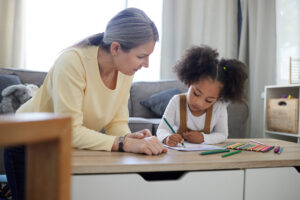 Expert school psychologist working with a young student during a counseling session