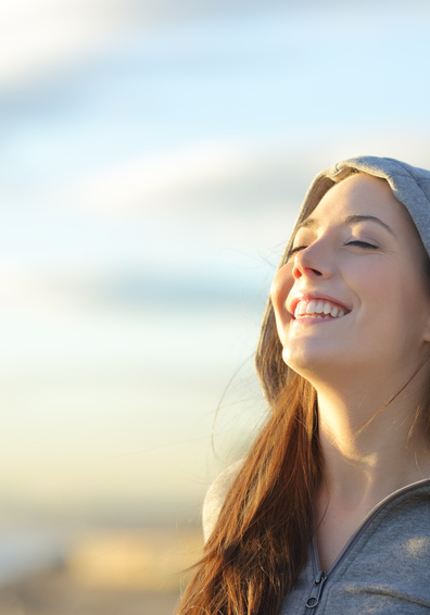 Image of young woman feeling relieved breathing fresh air